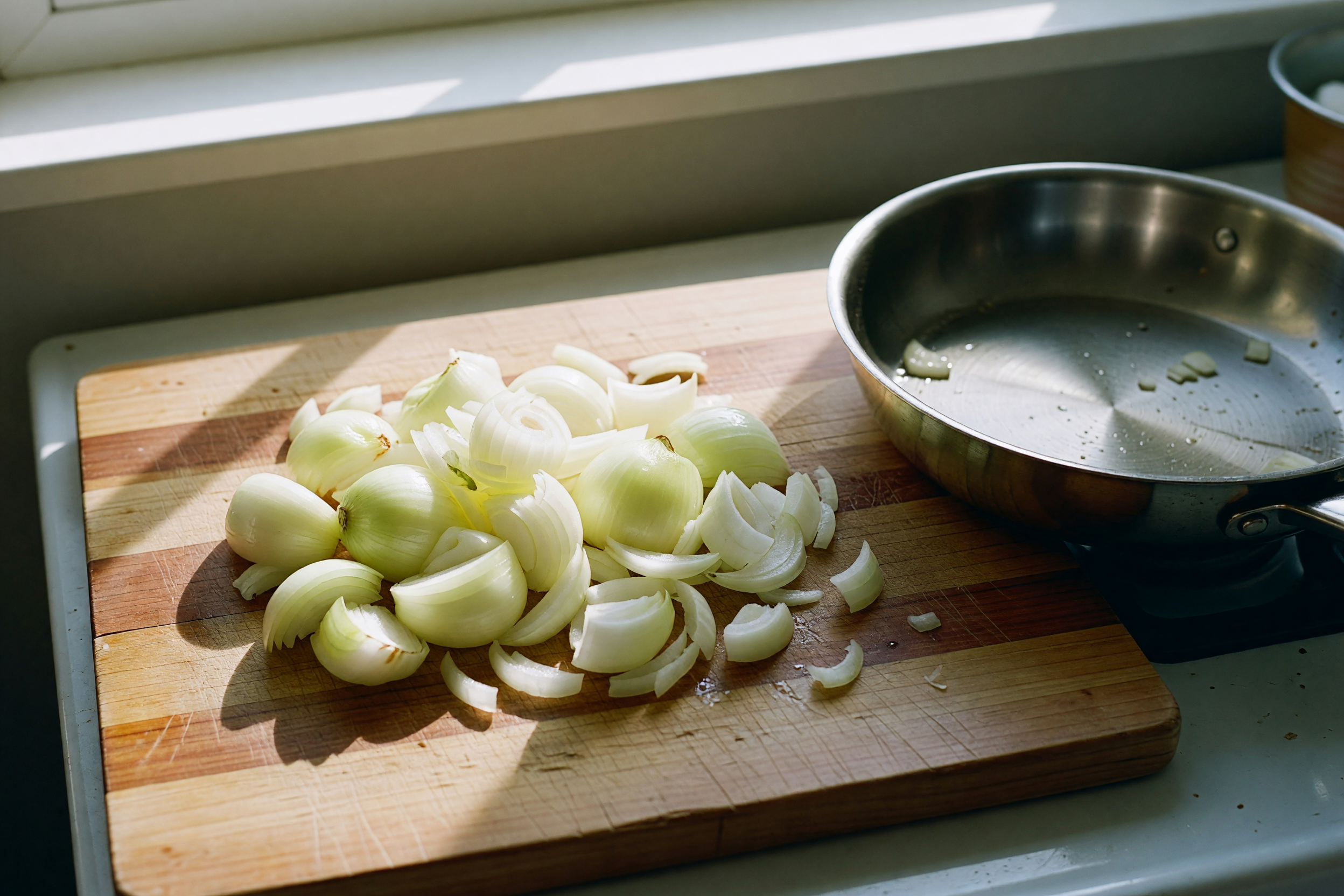 onions on the board, pan heating up