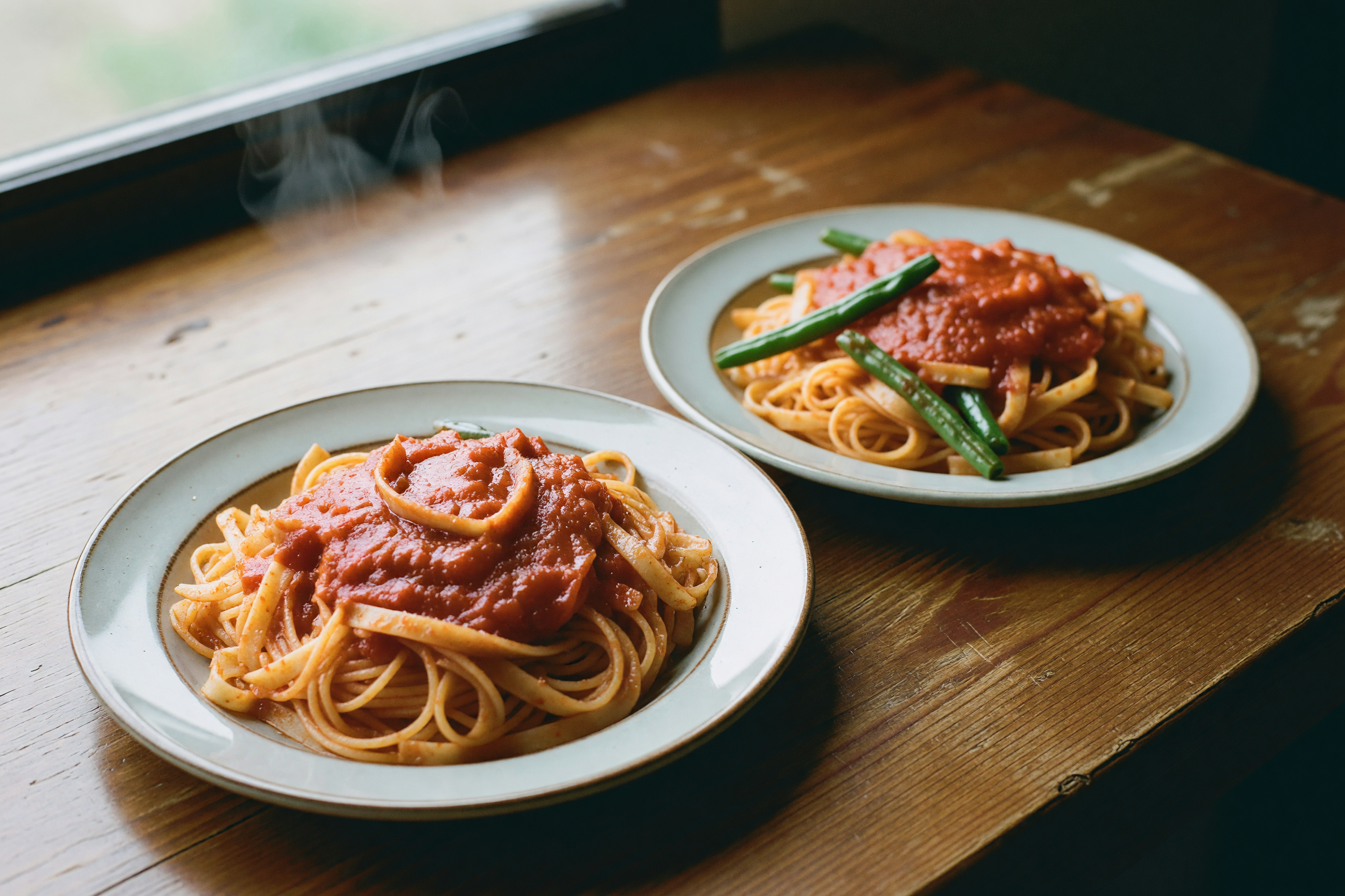 plates of pasta with the beans mixed in